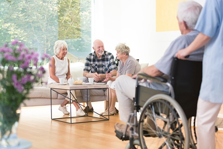 Elderly adults talking together around a table