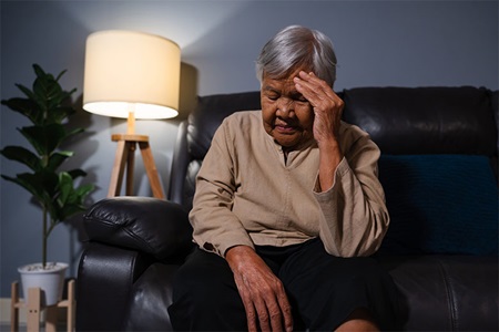 Elderly asian woman sitting on the sofa