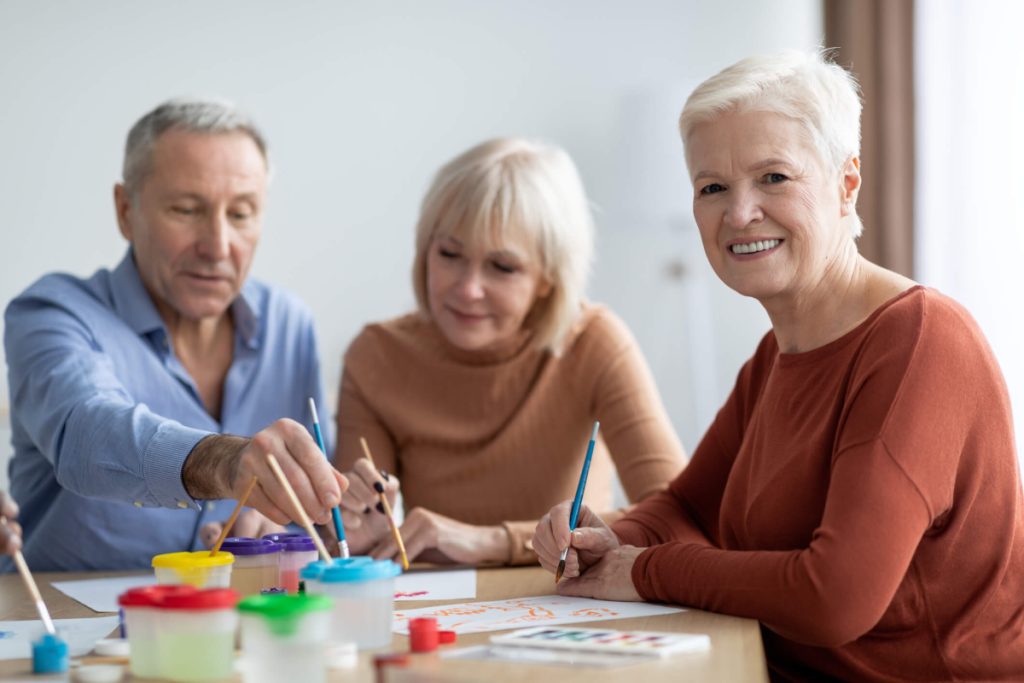Is assisted living right for you questions to ask family gathered around the table working on art activities
