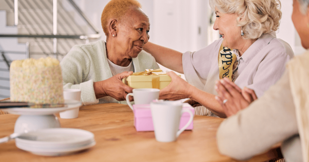 Elder women at the table with coffee and presents combatting senior loneliness